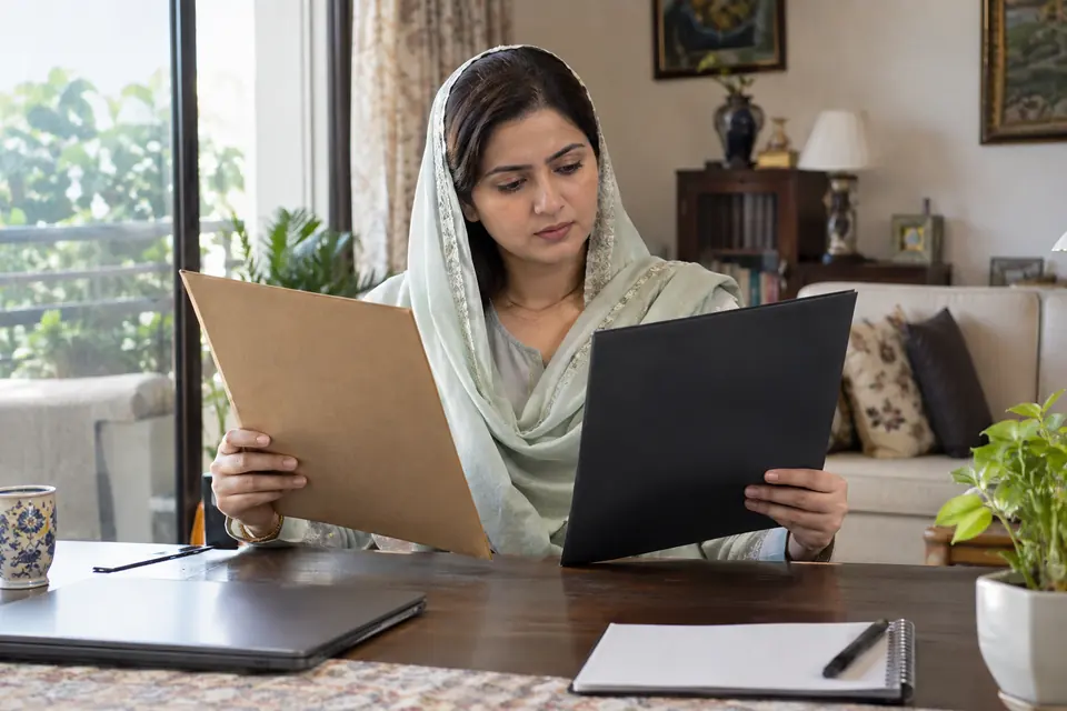Domestic Staff Verification: What Each Check Tells You: Staffing adviser comparing plain document folders.