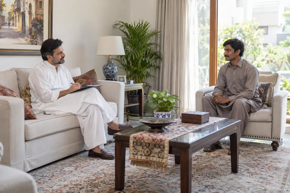 How to Hire Staff: Process, Fees & Replacement Cover How to Hire Staff: Process, Fees & Replacement Cover: Homeowner interviewing a male household helper in a living room.